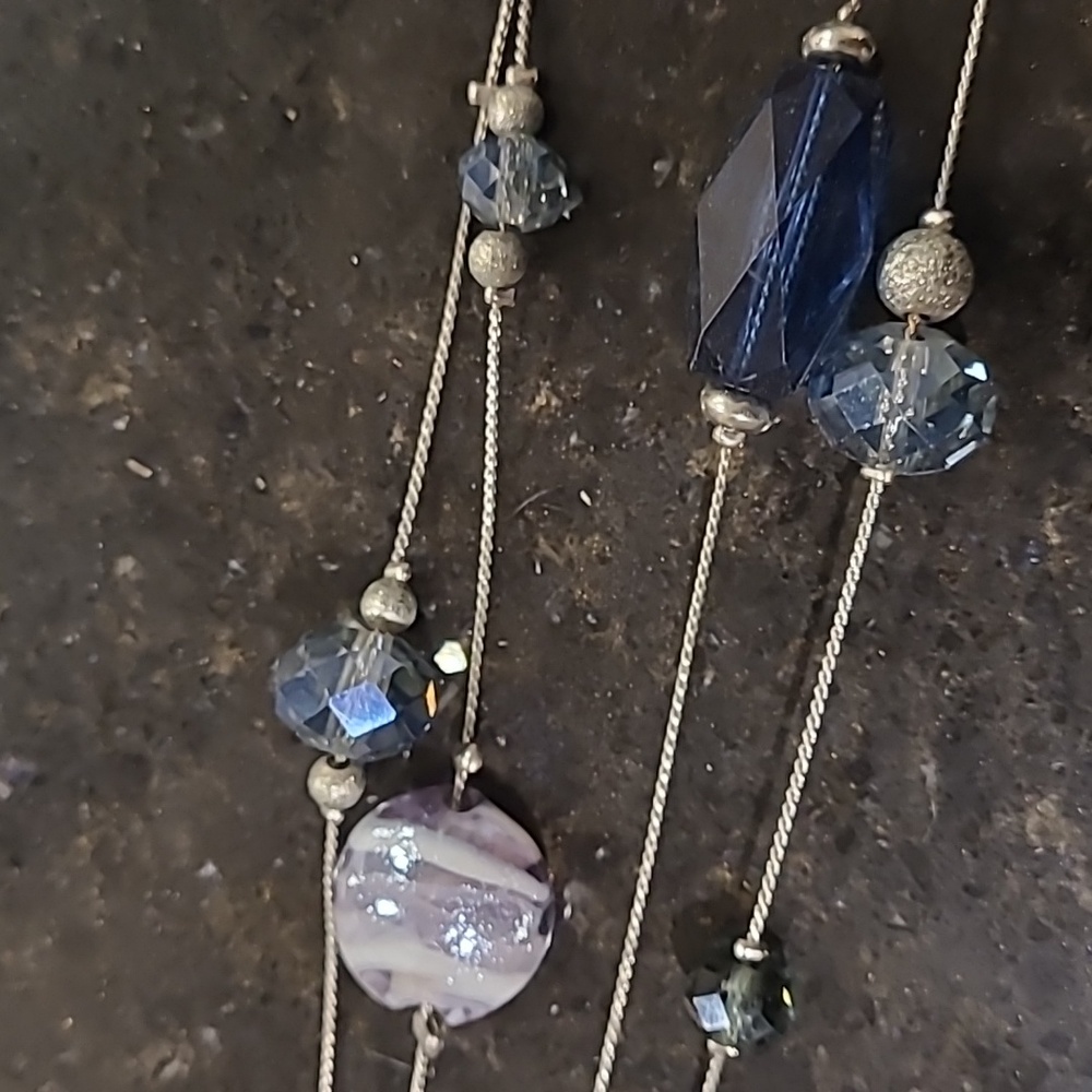 Women's silver and blue colored necklace.